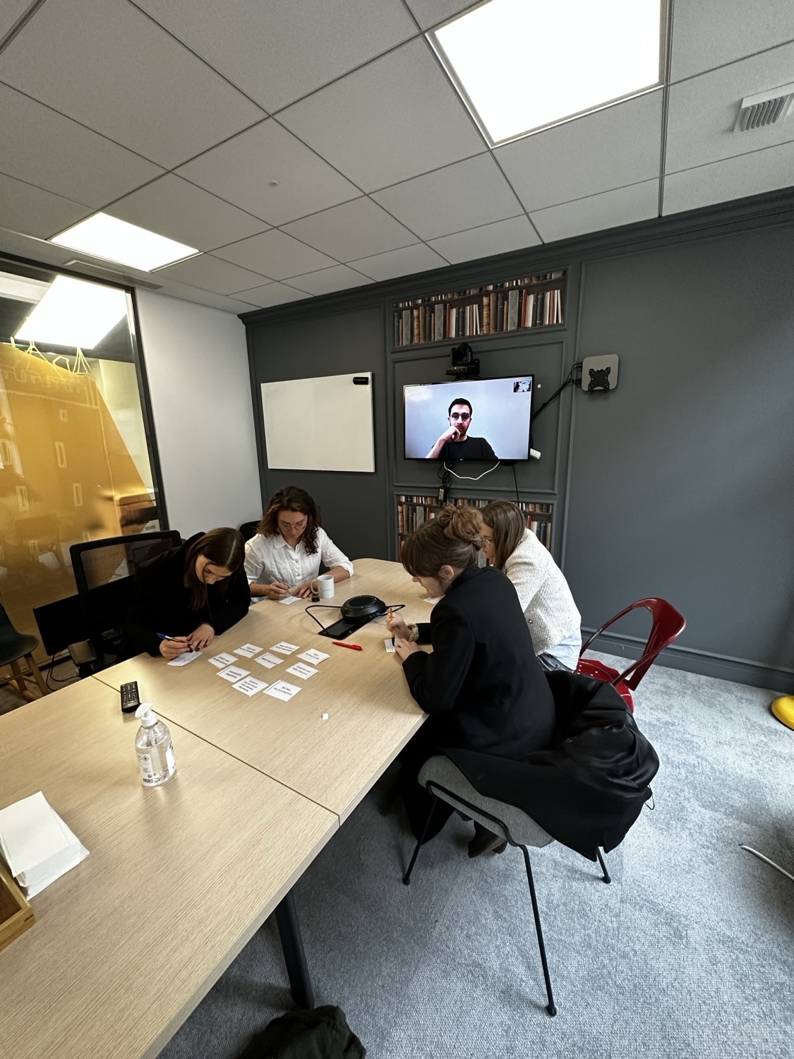 An in-field research session with students, a remote participant joining on screen